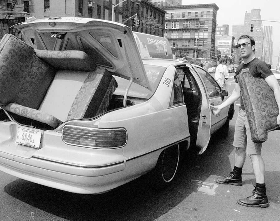 New Yorkers love the subway, but sometimes you just need a cab. A man packs a taxi full with an armchair from a fleamarket along 6th Avenue.