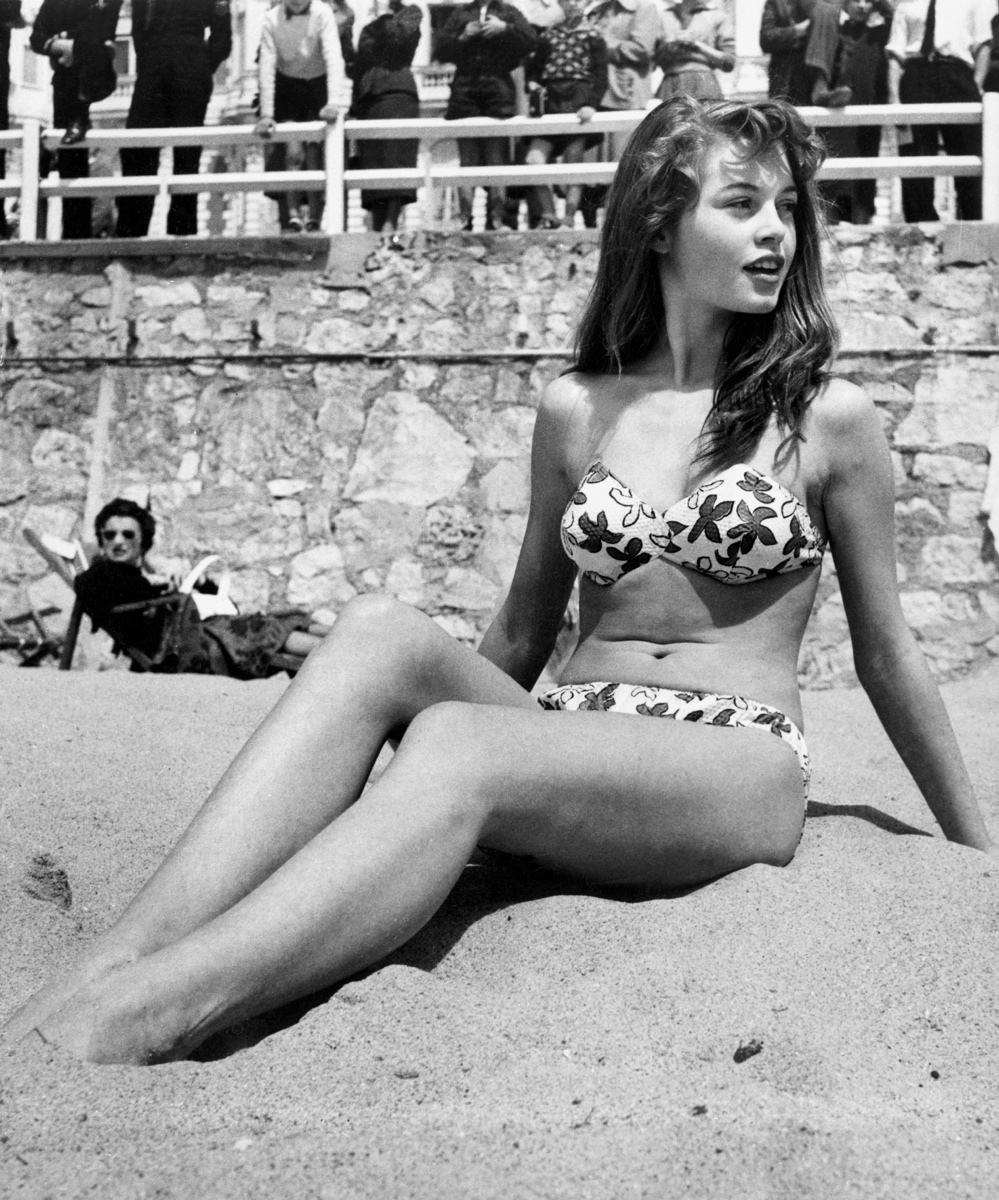 The gorgeous Brigitte Bardot donned a bikini while lounging on the beach during the Cannes Film Festival in 1953.