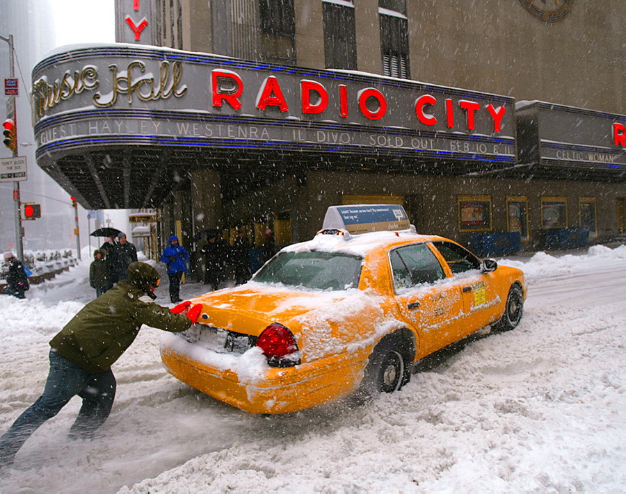 Good Samaritan George Yako helps push a cab stuck in the snow in front of Radio City Music Hall during a nor'easter that dumped 26.9 inches of snow in Central Park.