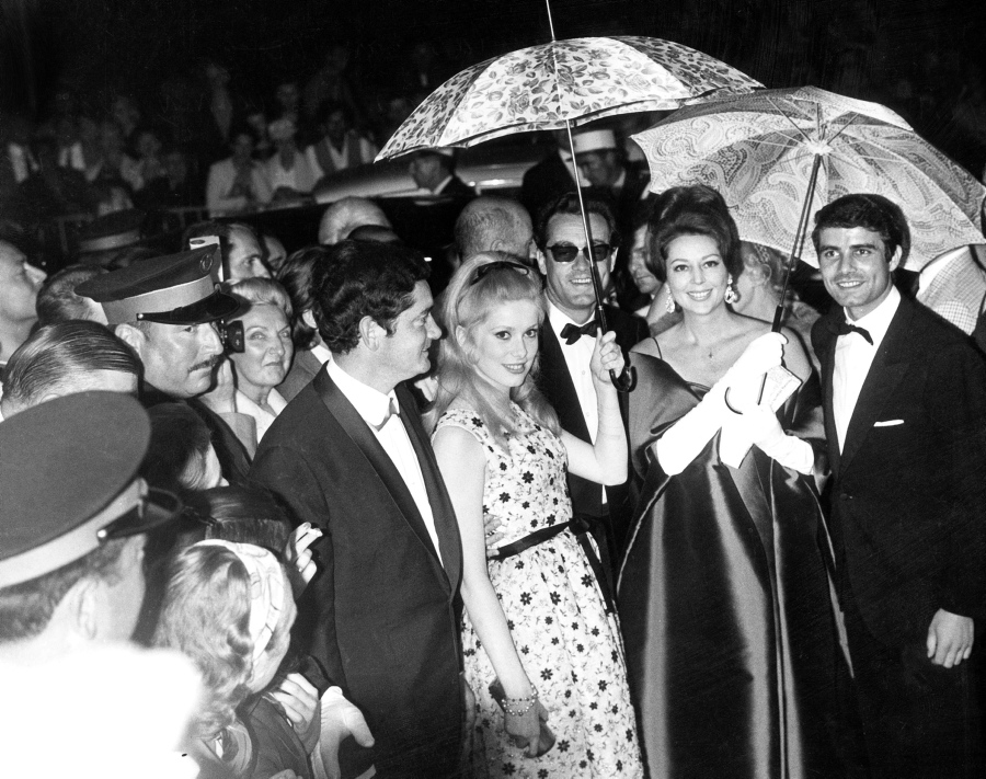 French actress Catherine Deneuve has been a mainstay at the Cannes Film Festival for years. She's seen here at Cannes in 1964, hiding from the rain under an umbrella. Deneuve's film 