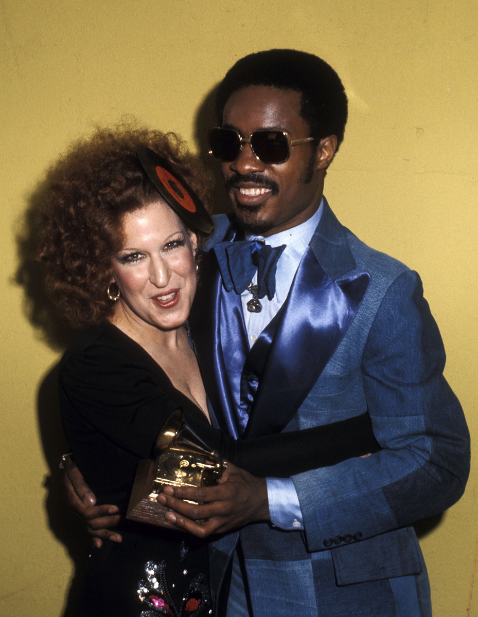 Stevie Wonder clutches onto Bette Midler and one of his five Grammys at the 16th Annual Grammy Awards. The music legend won Best R&B Song (songwriter) for 