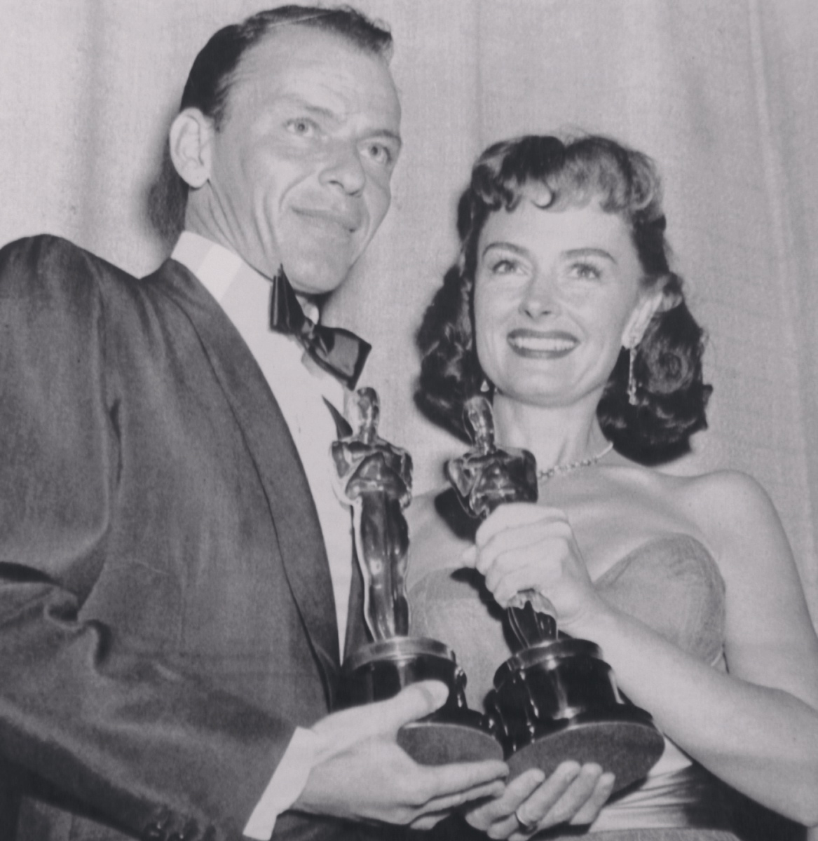 Frank Sinatra proudly smiles as he holds his first Oscar for his role in 