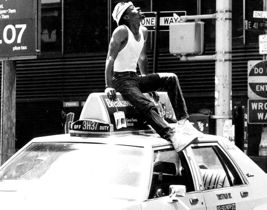 A cab stands broken down on 41st Street with driver Kevin Clement on the roof.